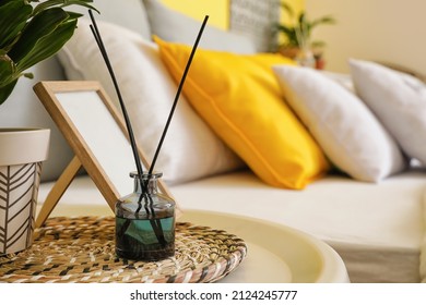 Aroma Reed Diffuser With Photo Frame On Table In Bedroom