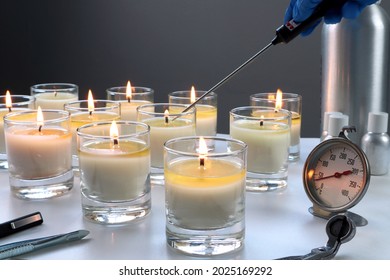 Aroma Scented Candle Glasses Are On The White Table With Fragrance Oil During The Burning Test Process In The Lab Checking For The Soot And Temperature Burning Time Before Selling In The Candle Market