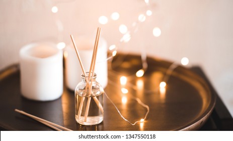 Aroma Sticks With Glass Bottle Over Glowing Lights At Background. Home Fragrance. 