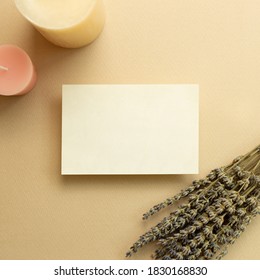 Aroma Therapy Concept. Memo Pad, Empty Paper With Dry Lavender Flowers And Candles On Beige Background. Top View, Copy Space