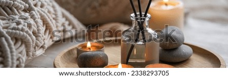 Aromatherapy, atmosphere of relax, serenity and pleasure. Concept of spa treatment in salon. Natural organic essential oil, towel, burning candles. Anti-stress, detox procedure, wellness. Banner