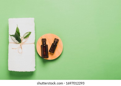 Aromatherapy Bottle Fresh Tea Tree Leaf Oil Soft White Towel For Cosmetic Spa Treatments Pastel Green Mint Background .