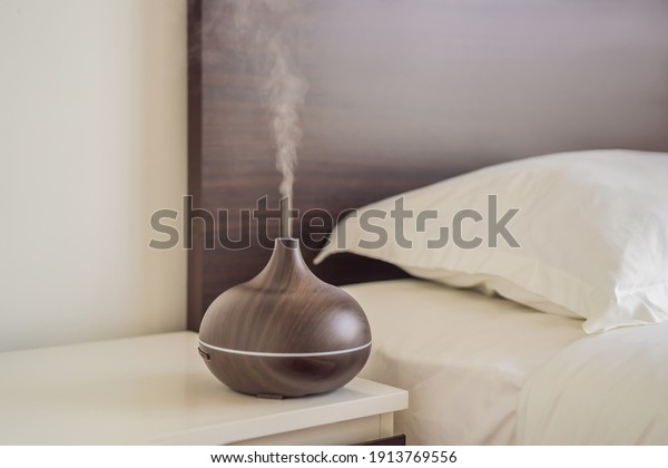 Aromatherapy Concept. Wooden Electric Ultrasonic\
Essential Oil Aroma Diffuser and Humidifier. Ultrasonic aroma\
diffuser for home