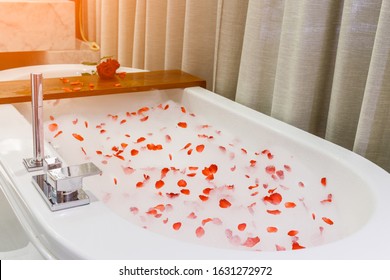 Aromatherapy with flower petals.Bath water with rose petals.Valentine's Day.top view,Red rose petal scattered on the white bath bubble,Jacuzzi tub,White bathtub for romantic bathroom in honeymoon suit - Powered by Shutterstock