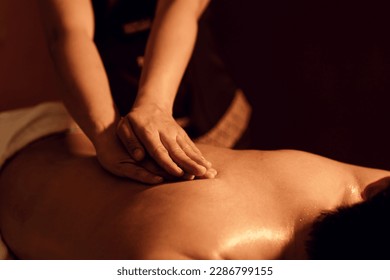 Aromatherapy massage, Masseuse hand massage aroma on back a man customer in cosmetology spa centre. Relaxation man customer get service aromatherapy massage with masseuse in spa salon. Selective focus
