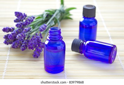 Aromatherapy oil in bottles with fresh lavenders
