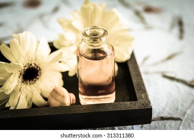 Aromatherapy oil for spa with gerbera flower on dish made with vintage style