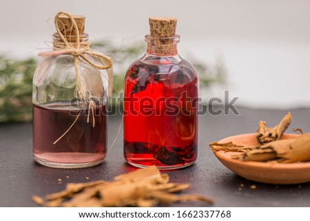 aromatherapy oils and pieces of cinnamon decent with rosemary.
