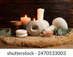 Aromatherapy. Scented candles, eucalyptus branches and spa products on wooden table