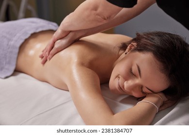 Aromatherapy Session, Essential Tranquility, Essential Oils. In serene environment beauty spa, woman is receiving massage enriched with essential oils.