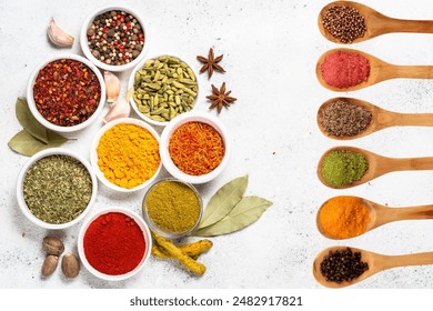 Aromatic Assortment of Spices and Herbs for Culinary Delights a variety of spices and herbs arranged on a dark, circular stone surface. Small bowls contain ingredients Various spices and herbs in bowl - Powered by Shutterstock