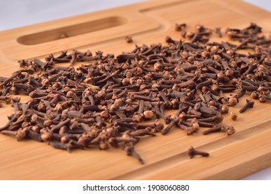 Aromatic Cloves Magnified On A Wooden Kitchen Board, Spices And Aromas. Large Depth Of Field.