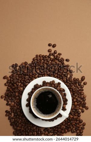 Aromatic coffee in cup and beans on beige background, flat lay. Space for text