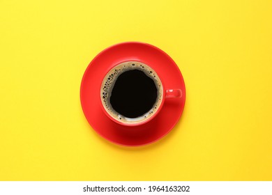 Aromatic Coffee In Red Cup On Yellow Background, Top View