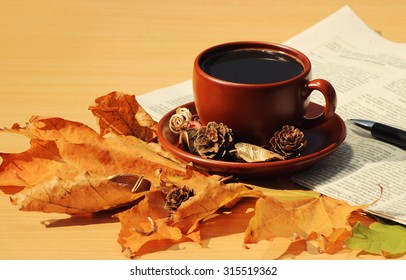 Aromatic cup of coffee on the table in the autumn