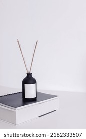 Aromatic Diffuser On Books Stack. Home Office Decoration Desk Concept.