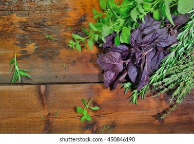 Aromatic Herbs (rosemary, Thyme, Basil, Mint)  On Wooden Background. Overhead View