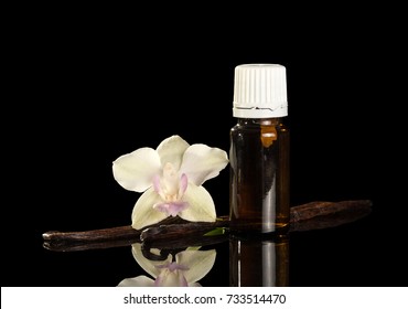 Aromatic Liquid For Smoking In Bottle, Flower And Vanilla Pod, Isolated On Black Background