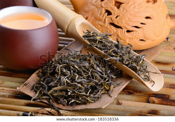 Aromatic
oolong tea from China on bamboo mat
background