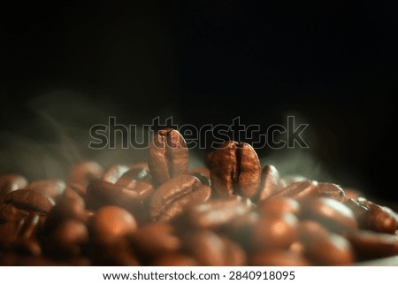 Aromatic Roasted Coffee Beans with Subtle Smoke. Atmospheric close-up photograph of freshly roasted coffee beans enveloped in gentle wisps of smoke, evoking a warm, rich, and inviting aroma.