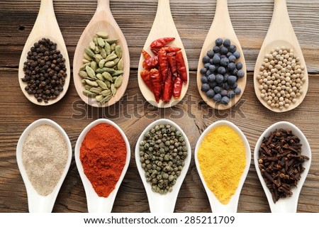 Aromatic spices on wooden spoons. Food ingradients.