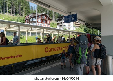 Arosa, GR / Switzerland - 24. July, 2019: Tourists Getting On And Off The Open Panorama Carriage Of The Scenic Chur - Arosa Train Line In The Swiss Alps