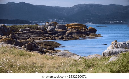 Arousa Island. Several people walk among the rocks. - Powered by Shutterstock