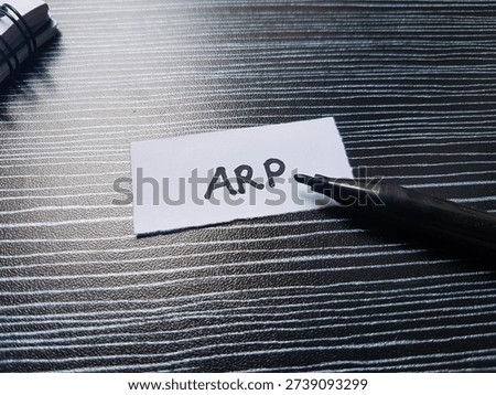 Arp writting on table background. 