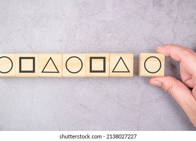 Arrange the geometry shape on the wood cubes into same sequence pattern, standardized, logic, or basic IQ test concept - Shutterstock ID 2138027227