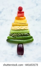 Arrangement assorted fruit   vegetables in rainbow gradient in shape triangle  tree  pyramid  eat healthy during festive holidays concept