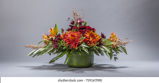 Arrangement of bright, colorful, red, and orange flowers isolated on grey background - Shutterstock ID 759167098