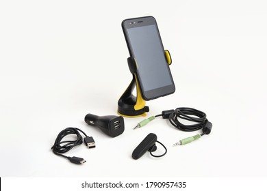 Arrangement of car mobile accessories including holder and AUX cable, charger and handsfree