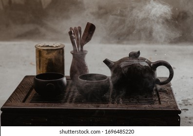 An arrangement of a cast iron tea pot, matcha powder and tea whisk - Shutterstock ID 1696485220