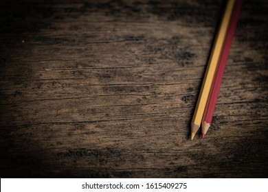 Arrangement Of Colored Pencils On A Dark Brown Wooden Table. Cinematic Concept To Keep On Being Creative And A Way To Motivate Children To Continue Their Education.