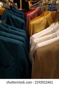 Arrangement Of Colorful Shirts Hanging On Straight Hangers