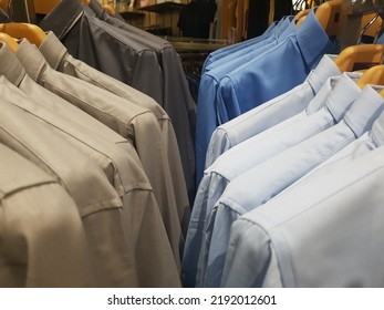 Arrangement Of Colorful Shirts Hanging On Straight Hangers