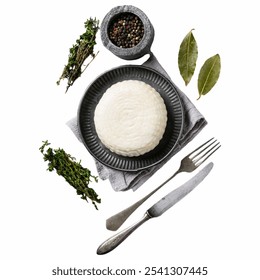 The arrangement features a pristine serving of rice alongside fresh thyme and bay leaves, complemented by a bowl of mixed peppercorns, showcasing culinary ingredients. - Powered by Shutterstock