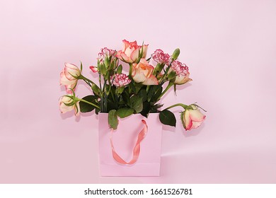 Arrangement of flowers on a pink isolated background, place for text, flat lay. Creative modern bouquet, minimal holiday and spring concept. Greeting card for Women's Day  happy birthday,