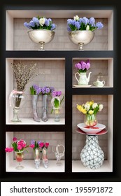Arrangement of flowers in a vase on the shelf - Shutterstock ID 195591872