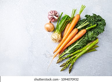 An Arrangement Of Fresh Vegetables For A Healthy Dish; Carrots, Kale, Asparagus, Celery, Onion, Garlic; Flatlay