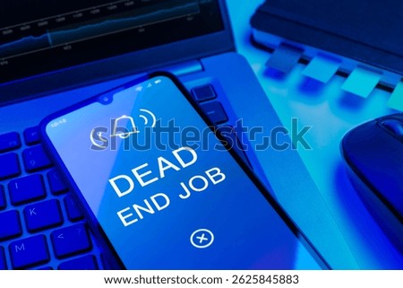 Arrangement of objects on an office desk expressing Dead End Job concept.