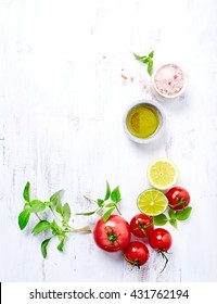 An arrangement of tomatoes, basil, olive oil and himalayan salt. Concept for healthy nutrition. White wooden background. Top view. Copy space.  - Shutterstock ID 431762194
