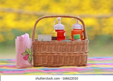 An Arrangement Of Various Gourmet Condiments In A Gift Basket.