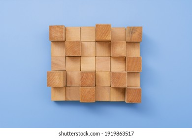 Arrangement Of Wooden Building Blocks On Blue Background.