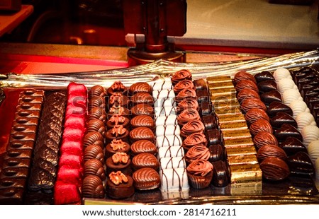 Arranges delicious assorted chocolates - dark, milk, white chocolate