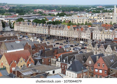 Arras, France - May 28, 2017: View from the city hall tower of people cand parked cars on the Grand Place market place or town square and the houses of the city in Arras in France on May 28, 2017