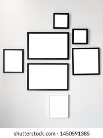 Array Of Black And White Wooden Photo Frames Mockup, Seven Set Collection On Neutral White Wall.