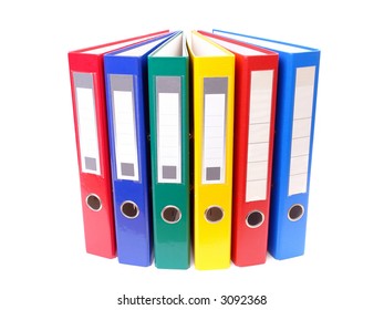 Array of colorful ring binders over white