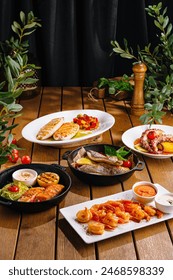 Array of delicious mediterranean dishes displayed on a wooden table, perfect for food enthusiasts