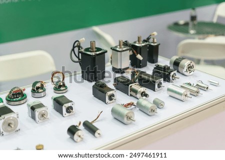 array of electric motors, including stepper motors, servo motors, and DC motors, displayed on a white surface